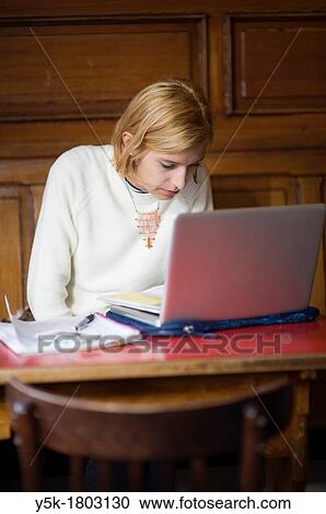 Rotterdam, Netherlands. Young, attractive woman working in a cafe. View Large Photo Image Stock Image - Rotterdam, Netherlands. Young, attractive woman working in a cafe.. Fotosearch