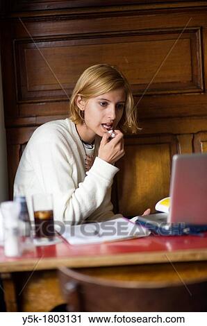 Rotterdam, Netherlands. Young, attractive woman working in a cafe. View Large Photo Image Stock Image - Rotterdam, Netherlands. Young, attractive woman working in a cafe.. Fotosearch