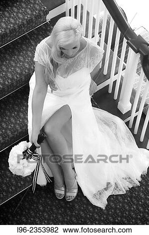 Sexy vintage blond bride sitting on stairs in her wedding dress with legs exposed View Large Photo Image Stock Image - Sexy vintage blond bride sitting on stairs in her wedding dress with legs exposed. Fotosearch
