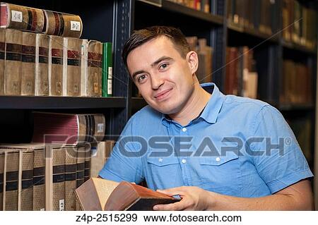 Student in library looking at camera. View Large Photo Image Stock Photo - Student in library looking at camera.. Fotosearch