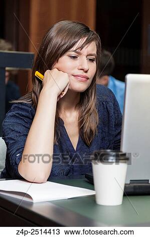 Stock Image - Student learning in library. Fotosearch