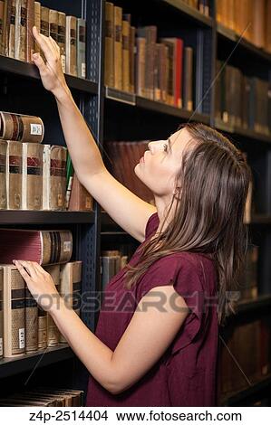 Student takes a book in library View Large Photo Image Picture - Student takes a book in library. Fotosearch