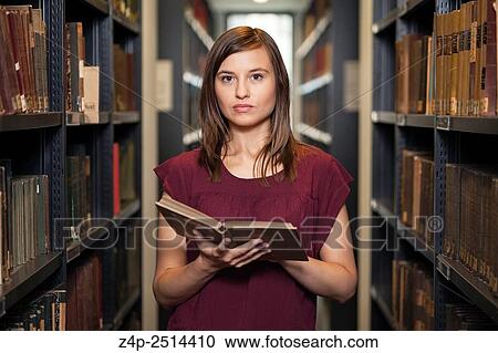 Student with a book in library View Large Photo Image Stock Image - Student with a book in library. Fotosearch