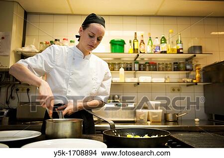 The chef of a vegetarian restaurant, preparing meals in the kitchen of the restaurant. View Large Photo Image Picture - The chef of a vegetarian restaurant, preparing meals in the kitchen of the restaurant.. Fotosearch
