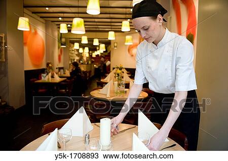 The chef of an vegetarian restaurant, setting one of the table´s for her guests. View Large Photo Image Stock Image - The chef of an vegetarian restaurant, setting one of the table´s for her guests.. Fotosearch