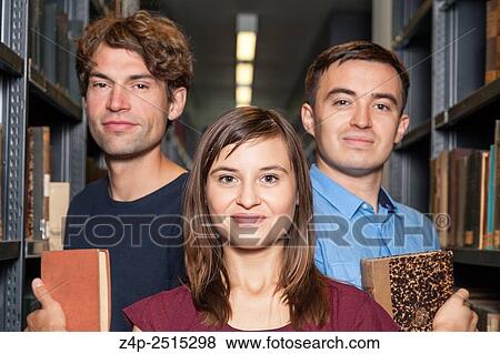 Stock Photo - Three students in a library. Fotosearch