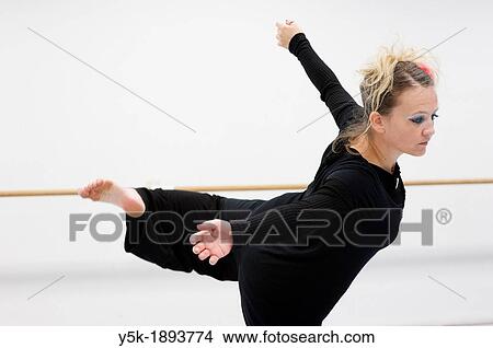 Picture - Tilburg, Netherlands. A professional dancer and choreographer of modern dance during a rehearsal of improvised, modern dance.. Fotosearch