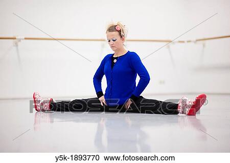 Tilburg, Netherlands. A professional dancer and choreographer of modern dance busy stretching and straightening her muscles before a rehearsal of improvised, modern dance. View Large Photo Image Stock Image - Tilburg, Netherlands. A professional dancer and choreographer of modern dance busy stretching and straightening her muscles before a rehearsal of improvised, modern dance.. Fotosearch