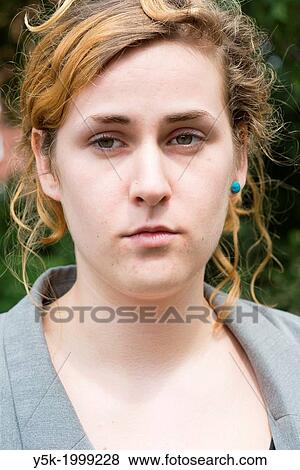 Stock Photo - Tilburg, Netherlands. A young woman during her visit to a deceased person on a local cemetery.. Fotosearch
