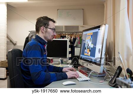 Tilburg, Netherlands. Graphic designer and art director working on an assignment behind his desk with an Apple iMac computer. View Large Photo Image Stock Image - Tilburg, Netherlands. Graphic designer and art director working on an assignment behind his desk with an Apple iMac computer.. Fotosearch