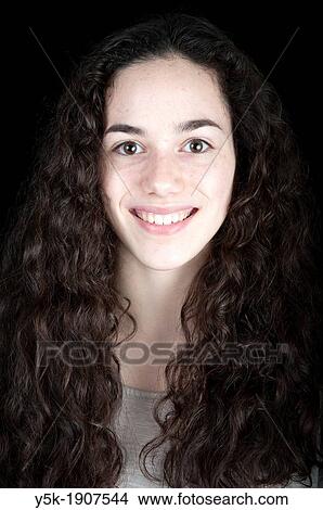 Tilburg, Netherlands Portrait of a young brunette woman with a smile against a black background View Large Photo Image Picture - Tilburg, Netherlands Portrait of a young brunette woman with a smile against a black background. Fotosearch