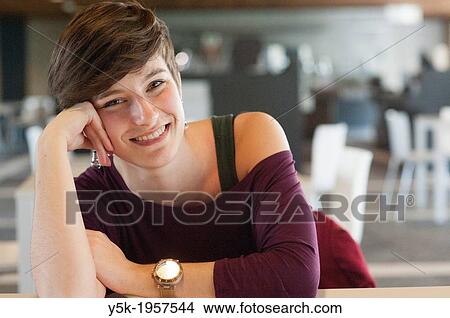 Tilburg, Netherlands. Portrait of a young brunette Philosophy student at Tilburg University, having a break in one of the coffee rooms in the main building. View Large Photo Image Picture - Tilburg, Netherlands. Portrait of a young brunette Philosophy student at Tilburg University, having a break in one of the coffee rooms in the main building.. Fotosearch