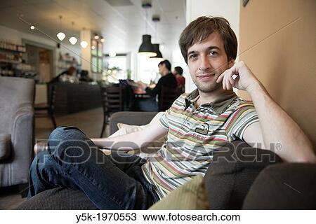 Tilburg, Netherlands. Portrait of a young intellectual male, during a conversation in a coffee place down town Tilburg. View Large Photo Image Stock Image - Tilburg, Netherlands. Portrait of a young intellectual male, during a conversation in a coffee place down town Tilburg.. Fotosearch