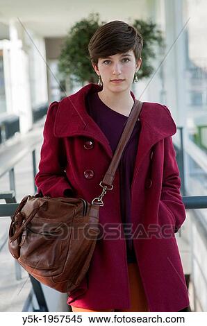 Tilburg, Netherlands. Portrait of a young brunette Philosophy student at Tilburg University, walking down a corridor towards the main building. View Large Photo Image Stock Photography - Tilburg, Netherlands. Portrait of a young brunette Philosophy student at Tilburg University, walking down a corridor towards the main building.. Fotosearch