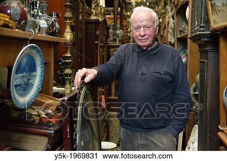 Tilburg, Netherlands. Portrait of the 72 year old owner of an antique wholesale company on the eastern industrial estate in town. View Large Photo Image Stock Image - Tilburg, Netherlands. Portrait of the 72 year old owner of an antique wholesale company on the eastern industrial estate in town.. Fotosearch