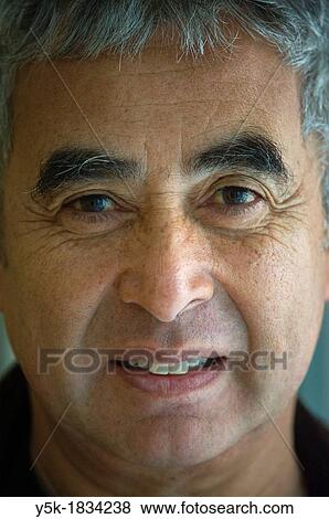 Stock Photo - Tilburg, Netherlands. Portrait / headshot of a middle-aged Dutch - Indonesian man, front view.. Fotosearch