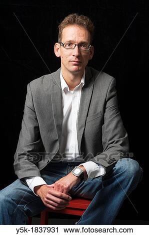 Tilburg, Netherlands. Studio-portrait of a long man with glasses. View Large Photo Image Stock Image - Tilburg, Netherlands. Studio-portrait of a long man with glasses.. Fotosearch