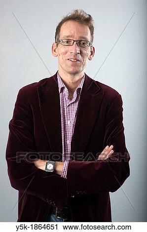 Tilburg, Netherlands. Studio-portrait of a long man with glasses. View Large Photo Image Stock Image - Tilburg, Netherlands. Studio-portrait of a long man with glasses.. Fotosearch
