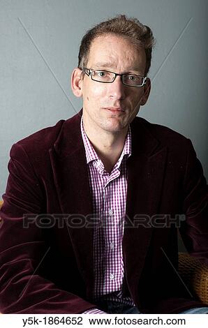 Tilburg, Netherlands. Studio-portrait of a long man with glasses. View Large Photo Image Stock Image - Tilburg, Netherlands. Studio-portrait of a long man with glasses.. Fotosearch