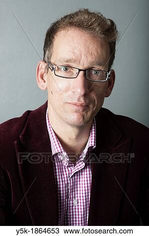 Tilburg, Netherlands. Studio-portrait of a long man with glasses. View Large Photo Image Stock Image - Tilburg, Netherlands. Studio-portrait of a long man with glasses.. Fotosearch