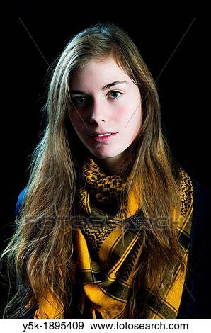 Tilburg, Netherlands. Studio-portrait of a young woman against a black background. View Large Photo Image Stock Photo - Tilburg, Netherlands. Studio-portrait of a young woman against a black background.. Fotosearch