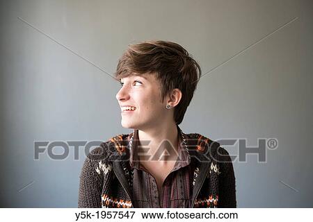 Stock Photo - Tilburg, Netherlands. Studio-portrait of a young brunette Philosophy student at Tilburg University, looking sideways, shoulders-up.. Fotosearch