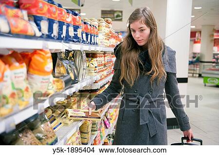 Tilburg, Netherlands. Young woman buying groceries in a supermarket. View Large Photo Image Picture - Tilburg, Netherlands. Young woman buying groceries in a supermarket.. Fotosearch