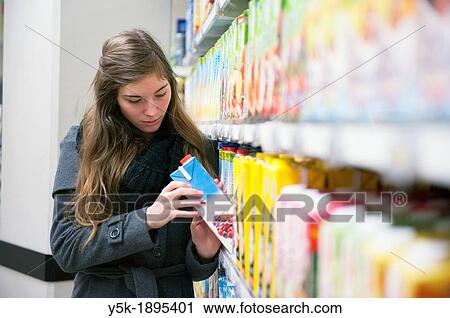 Tilburg, Netherlands. Young woman buying groceries in a supermarket. View Large Photo Image Stock Image - Tilburg, Netherlands. Young woman buying groceries in a supermarket.. Fotosearch