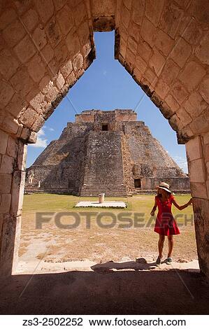 Tourist walking around the Pyramid of the Magician, Maya archeological site Uxmal, Yucatan, Mexico, Central America. View Large Photo Image Stock Image - Tourist walking around the Pyramid of the Magician, Maya archeological site Uxmal, Yucatan, Mexico, Central America.. Fotosearch