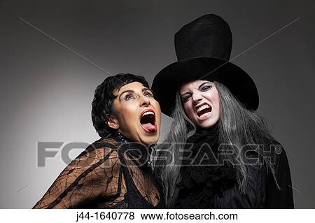 Two women wearing a witch and black widow costume View Large Photo Image Stock Photo - Two women wearing a witch and black widow costume. Fotosearch