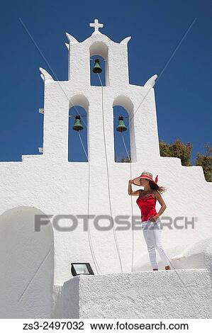Woman in front of a Cyclades church, Byzantine church of Agia Irini near the Ormos harbour, Ios, Cyclades Islands, Greek Islands, Greece, Europe. View Large Photo Image Stock Image - Woman in front of a Cyclades church, Byzantine church of Agia Irini near the Ormos harbour, Ios, Cyclades Islands, Greek Islands, Greece, Europe.. Fotosearch
