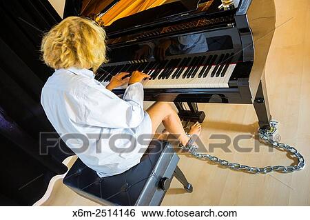 Woman playing a piano. View Large Photo Image Stock Photograph - Woman playing a piano.. Fotosearch