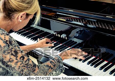Woman playing the piano. View Large Photo Image Stock Image - Woman playing the piano.. Fotosearch