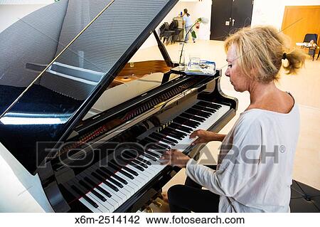 Woman playing the piano. View Large Photo Image Stock Image - Woman playing the piano.. Fotosearch