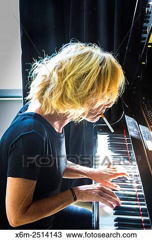 Woman playing the piano. View Large Photo Image Stock Image - Woman playing the piano.. Fotosearch