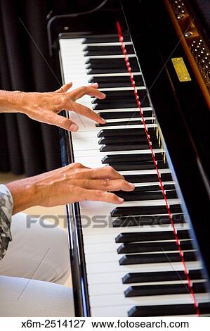 Stock Photo - Woman playing the piano.. Fotosearch
