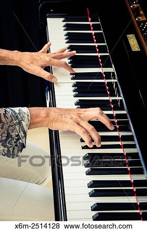 Stock Photo - Woman playing the piano.. Fotosearch