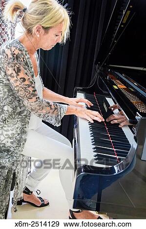 Woman playing the piano. View Large Photo Image Stock Photo - Woman playing the piano.. Fotosearch