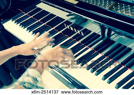 Stock Photo - Woman playing the piano.. Fotosearch