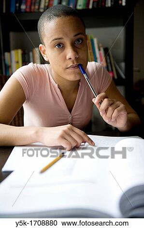 Young, African woman, making her home-work, while learning Dutch as a second language. View Large Photo Image Stock Image - Young, African woman, making her home-work, while learning Dutch as a second language.. Fotosearch