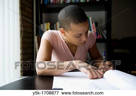 Young, African woman, making her home-work, while learning Dutch as a second language. View Large Photo Image Stock Photo - Young, African woman, making her home-work, while learning Dutch as a second language.. Fotosearch