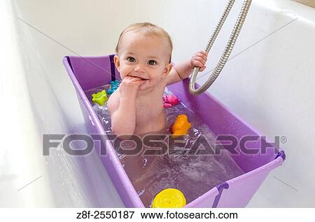 A baby girl (ca. 11 months old) has a bath at home. View Large Photo Image Stock Photo - A baby girl (ca. 11 months old) has a bath at home.. Fotosearch