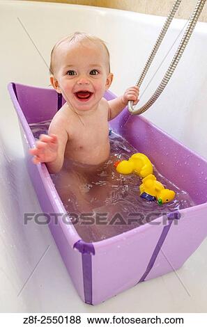 A baby girl (ca. 11 months old) has a bath at home. View Large Photo Image Stock Photo - A baby girl (ca. 11 months old) has a bath at home.. Fotosearch