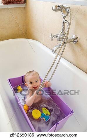 A baby girl (ca. 11 months old) has a bath at home. View Large Photo Image Stock Photograph - A baby girl (ca. 11 months old) has a bath at home.. Fotosearch