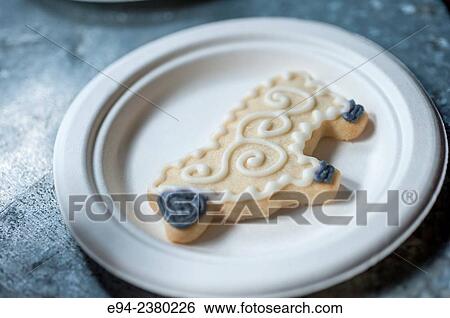A decorated cookie in the shape of an animal on a paper plate in a coffee shop. View Large Photo Image Stock Photograph - A decorated cookie in the shape of an animal on a paper plate in a coffee shop.. Fotosearch