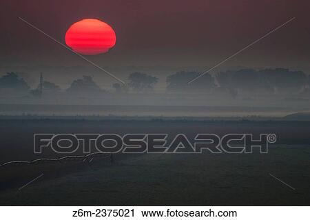 A temperature inversion creates a sun mirage over a foggy eastern Nebraska landscape. View Large Photo Image Stock Image - A temperature inversion creates a sun mirage over a foggy eastern Nebraska landscape.. Fotosearch