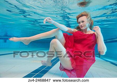 A young woman under water in a red dress View Large Photo Image Stock Photo - A young woman under water in a red dress. Fotosearch