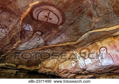 Stock Image - Aboriginal Wandjina cave artwork in sandstone caves at Raft Point, Kimberley, Western Australia, Australia.. Fotosearch