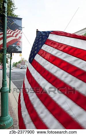 American flag blowing in the breeze on the main square in Noblesville, Indiana, IN, USA,. View Large Photo Image Stock Image - American flag blowing in the breeze on the main square in Noblesville, Indiana, IN, USA,.. Fotosearch