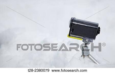 Stock Photo - An action camera at snow. Fotosearch